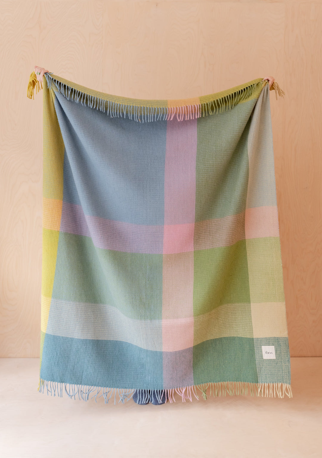 TBCo Recycled Wool Blanket in Green Waffle Block pattern featuring pastel colour blocks and fringe detail, displayed hanging