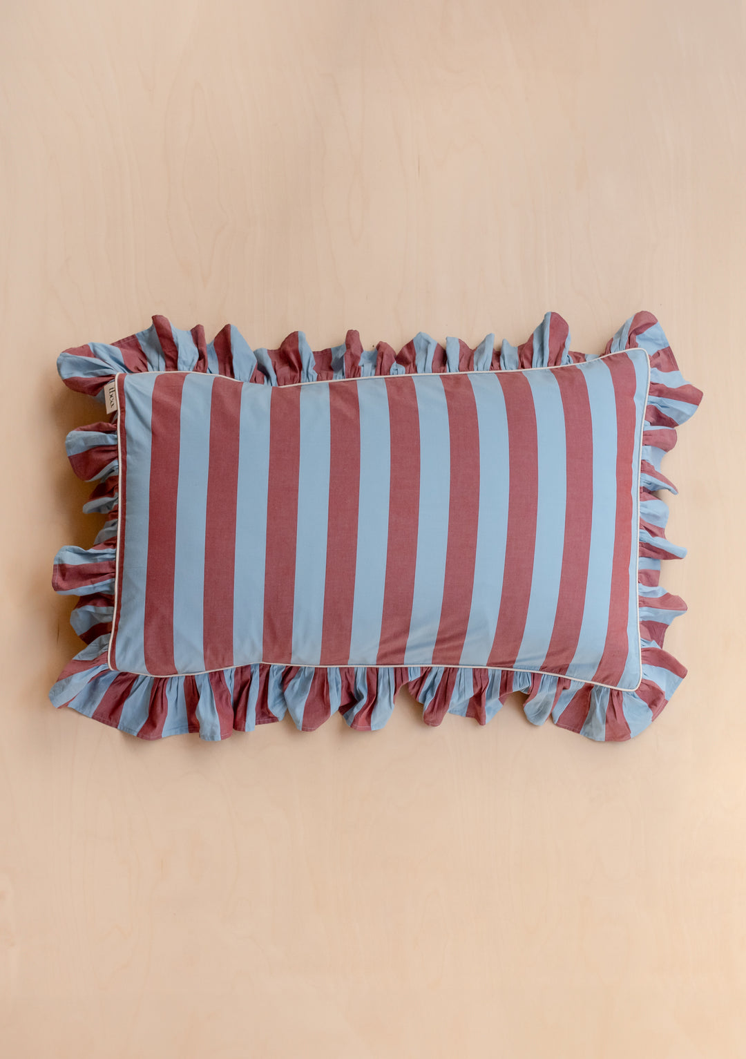 TBCo cotton pillowcase with blue and burgundy stripes and delicate ruffle trim, showcasing classic British bedding design