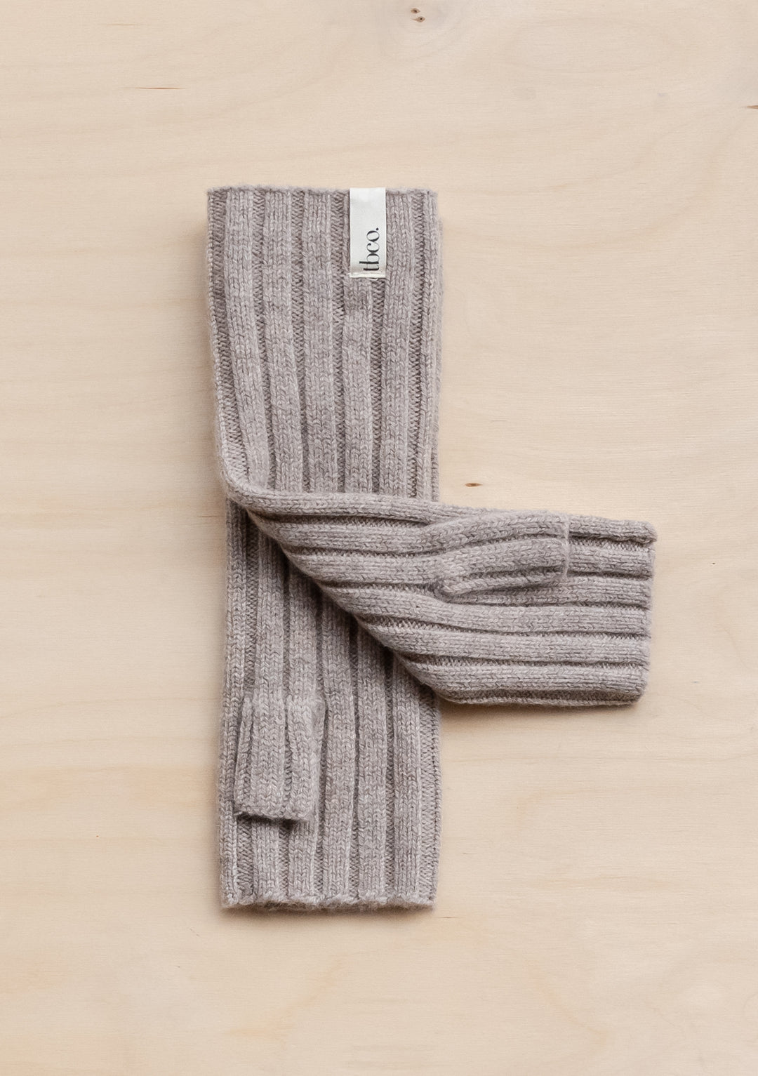 TBCo Cashmere & Merino Wrist Warmers in Oatmeal Melange shown flat with ribbed texture detail against neutral background